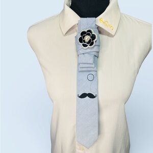 Elegant Baby Blue Necktie with Mustache Design and Flower Brooch